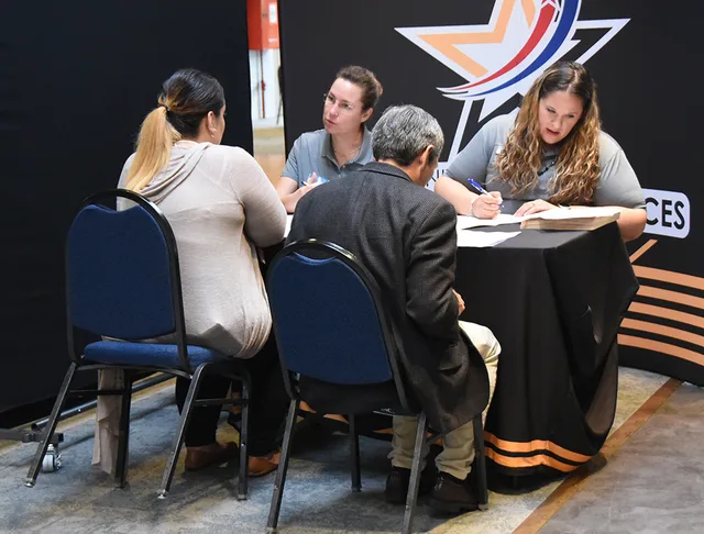Julia Merrick-Rocha (back left) and Jessica Ross (back right), Child and Youth Services employees, review applications and résumés during CYS's on-the-spot hiring sessions during the Benelux Employment, Volunteer and Career Expo Sept. 6, 2018, on SHAPE, Belgium. CYS and other organizations accepted. Industry dress codes mistakes: the traps and the way around them